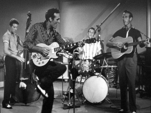 Carl Perkins performing onstage. Original source: Wikipedia, en.wikipedia.org/wiki/Carl_Perkins.